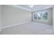 Bright primary bedroom featuring large windows and neutral decor at 8409 Darcy Hopkins Dr, Charlotte, NC 28277