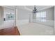 Elegant dining room featuring a modern chandelier, wainscoting, and natural light at 8409 Darcy Hopkins Dr, Charlotte, NC 28277