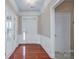 Inviting foyer with hardwood floors, white trim, and a glimpse of a bright, open living space at 8409 Darcy Hopkins Dr, Charlotte, NC 28277