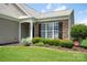Charming home featuring stone accents, manicured landscaping, and a welcoming front porch at 8409 Darcy Hopkins Dr, Charlotte, NC 28277