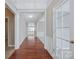 Hallway view showcases hardwood floors with crown molding and leads to a naturally lit living area at 8409 Darcy Hopkins Dr, Charlotte, NC 28277