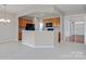 Open kitchen featuring stainless steel appliances and a breakfast bar overlooking the living area at 8409 Darcy Hopkins Dr, Charlotte, NC 28277