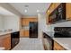 Bright kitchen featuring black appliances, tile floors, and lots of cabinet space at 8409 Darcy Hopkins Dr, Charlotte, NC 28277