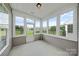 Enclosed sunroom with ample windows providing serene backyard views and natural light at 8409 Darcy Hopkins Dr, Charlotte, NC 28277