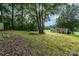 Backyard featuring a lawn, moss, trees, and the back of the house at 920 Manor Dr, Kings Mountain, NC 28086