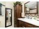 Elegant bathroom features a decorative mirror, vanity, and mosaic backsplash, creating a serene and refined space at 920 Manor Dr, Kings Mountain, NC 28086
