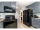 Kitchen area featuring stainless steel appliances and gray cabinets at 920 Manor Dr, Kings Mountain, NC 28086