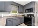Kitchen area with black appliances and gray cabinets at 920 Manor Dr, Kings Mountain, NC 28086