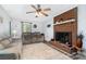 Inviting living room showcases a brick fireplace, ceiling fan, and plush seating for relaxation and comfort at 920 Manor Dr, Kings Mountain, NC 28086