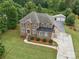 Beautiful brick home with a well-manicured lawn, mature trees, and a detached two-car garage in the background at 9450 Surface Hill Rd, Mint Hill, NC 28227