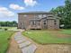Expansive backyard features a stepping stone pathway and lush lawn perfect for outdoor enjoyment and relaxation at 9450 Surface Hill Rd, Mint Hill, NC 28227