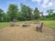 Inviting backyard with a fire pit and wooden swing, perfect for outdoor gatherings and relaxation at 9450 Surface Hill Rd, Mint Hill, NC 28227