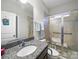 Bathroom with granite countertops, walk-in shower with accessibility features, and neutral color scheme for a calming effect at 9450 Surface Hill Rd, Mint Hill, NC 28227