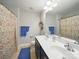Comfortable bathroom with double vanity, colorful shower curtain, and well-lit mirror at 9450 Surface Hill Rd, Mint Hill, NC 28227