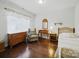 Bright bedroom features hardwood floors, a cozy chair, and plenty of natural light from the large window at 9450 Surface Hill Rd, Mint Hill, NC 28227