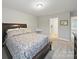 Bright bedroom featuring a wooden bed frame, neutral walls, and soft carpeting at 9450 Surface Hill Rd, Mint Hill, NC 28227