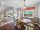 Dining area with hardwood floors and natural lighting, adjacent to a cozy living room at 9450 Surface Hill Rd, Mint Hill, NC 28227