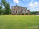Traditional brick home with a large, well-maintained front lawn and manicured landscaping showcasing its curb appeal at 9450 Surface Hill Rd, Mint Hill, NC 28227