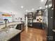 Kitchen featuring stainless steel appliances, dark cabinets, granite countertops and hardwood floors at 9450 Surface Hill Rd, Mint Hill, NC 28227