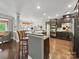 Kitchen featuring stainless steel appliances, dark cabinets, granite countertops and adjacent dining area at 9450 Surface Hill Rd, Mint Hill, NC 28227