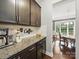 Kitchen featuring dark cabinets, granite countertops and a coffee bar at 9450 Surface Hill Rd, Mint Hill, NC 28227