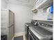 Functional laundry room with modern washer and dryer, storage shelves, and neat organization at 9450 Surface Hill Rd, Mint Hill, NC 28227