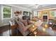 Cozy living room features a fireplace, hardwood floors, and comfortable seating arrangement at 9450 Surface Hill Rd, Mint Hill, NC 28227