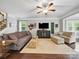 Cozy living room featuring hardwood floors, comfortable seating, and a ceiling fan, creating a relaxing atmosphere at 9450 Surface Hill Rd, Mint Hill, NC 28227