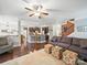 Open-concept living room flows into a modern kitchen with dark wood cabinets and stainless steel appliances, and hardwood floors at 9450 Surface Hill Rd, Mint Hill, NC 28227