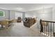 Bright upstairs living area with neutral carpet, cozy seating, and a staircase leading to other parts of the house at 9450 Surface Hill Rd, Mint Hill, NC 28227