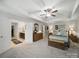 Main bedroom with access to an en-suite bathroom, plenty of closet space, and soft lighting for a cozy ambiance at 9450 Surface Hill Rd, Mint Hill, NC 28227