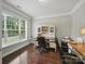 Well-lit home office featuring a large window, built-in shelving, and ample workspace for productivity at 9450 Surface Hill Rd, Mint Hill, NC 28227