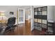 Functional home office space with hardwood floors, storage shelves, and ample room for a comfortable work environment at 9450 Surface Hill Rd, Mint Hill, NC 28227