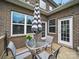 Cozy outdoor patio with a table, chairs, and stylish umbrella for outdoor enjoyment at 9450 Surface Hill Rd, Mint Hill, NC 28227