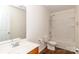 Bathroom with a single vanity, toilet, and a shower-tub combo with white tile surround at 1007 Green Terra Rd, Indian Trail, NC 28079