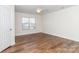 Bedroom featuring laminate flooring, a ceiling fan, and a large window with natural light at 1007 Green Terra Rd, Indian Trail, NC 28079