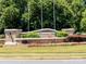 Landscaped community entrance with brick sign, flowering plants and manicured lawn at 1007 Green Terra Rd, Indian Trail, NC 28079