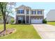 Charming two-story home with a well-manicured lawn and a two-car garage at 1007 Green Terra Rd, Indian Trail, NC 28079
