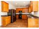 Modern kitchen featuring stainless steel appliances, granite countertops, and natural wood cabinetry at 1007 Green Terra Rd, Indian Trail, NC 28079