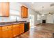 Cozy kitchen with hardwood floors, granite countertops, and a view into the adjacent living area at 1007 Green Terra Rd, Indian Trail, NC 28079