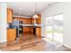 Bright kitchen boasts wood cabinets, black appliances, and access to the backyard at 1007 Green Terra Rd, Indian Trail, NC 28079