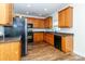 Traditional kitchen features wood cabinets, granite counters, and black appliances at 1007 Green Terra Rd, Indian Trail, NC 28079