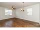Bright living room with hardwood floors, natural light, and a modern chandelier-style light fixture at 1007 Green Terra Rd, Indian Trail, NC 28079