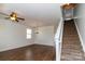 Bright living room featuring hardwood floors, fresh neutral paint, and a staircase to the upper level at 1007 Green Terra Rd, Indian Trail, NC 28079