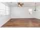 Spacious living room with hardwood floors, natural light from large windows, and a contemporary ceiling fan at 1007 Green Terra Rd, Indian Trail, NC 28079