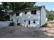 Spacious backyard featuring white brick exterior, ample parking, and exterior doors at 1038 Holmes Ave, Salisbury, NC 28144