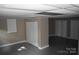 Neutral-toned basement featuring three closets, window, and gray concrete floors at 1038 Holmes Ave, Salisbury, NC 28144