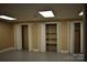 Neutral-toned basement featuring three closets, shelving, and gray concrete floors at 1038 Holmes Ave, Salisbury, NC 28144