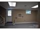 Unfinished basement featuring neutral walls, window, and door with access to the outside at 1038 Holmes Ave, Salisbury, NC 28144