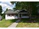 Charming one-story home with well-kept lawn, sidewalk, and mature trees at 1038 Holmes Ave, Salisbury, NC 28144